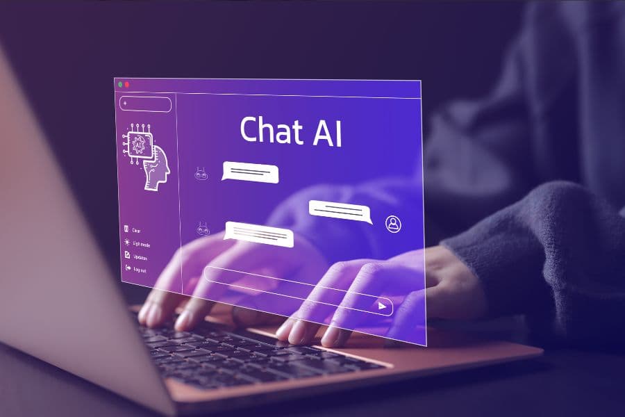 Hands typing on a laptop with a holographic display showing "Chat AI" and message bubbles, indicating artificial intelligence interaction.